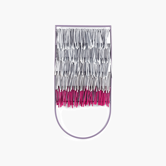 An oversized brooch in magenta and white, evoking summer's essence with its captivating design. Metal tassels gracefully sway, adding movement to the voluminous accessory. Crafted from polymer-coated metal for durability. Dimensions: 5 x 2-1/2 inches.