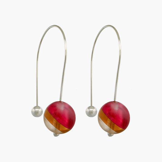 Close-up of layered acrylic sphere earrings with a mesmerizing 3D effect, created by multiple layers of high-quality acrylic. The earrings are suspended from sterling silver arcs and are lightweight and comfortable to wear. These earrings are a stylish and versatile accessory that can add a touch of elegance to any outfit.