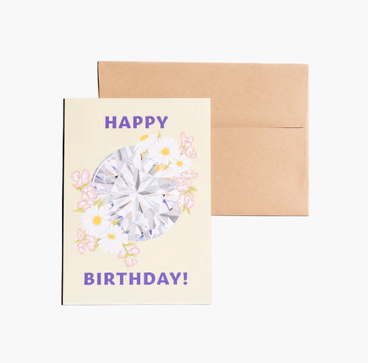 Front of the birthday card features a joyful message saying 'Happy Birthday,' adorned with a sparkling diamond, a delicate daisy, and a sweet pea, creating a charming and celebratory design. The inside is blank, ready for your personalized wishes. Comes with a kraft envelope for a rustic touch.