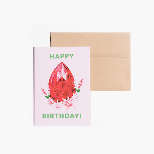 Birthday card showcasing an illustrated July birthstone of ruby and birth flowers of water lily and larkspur.
