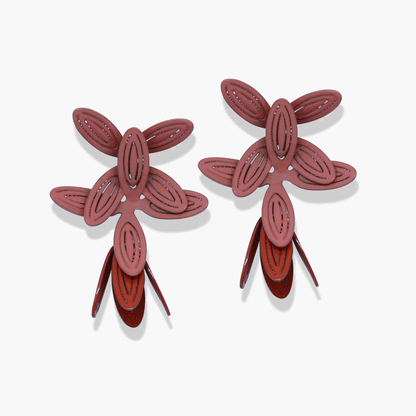 Fancy Petal Drops in guava/redwood: eye-catching earrings with large overlapping petal shapes in a stunning coral hue, featuring a hanging tulip shape. Sterling silver posts for comfortable wear. Bold design with vibrant color.