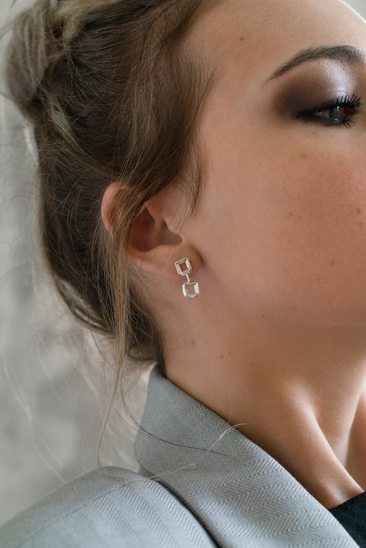 Model wearing sterling silver RUDO earrings by Kim Paquet
