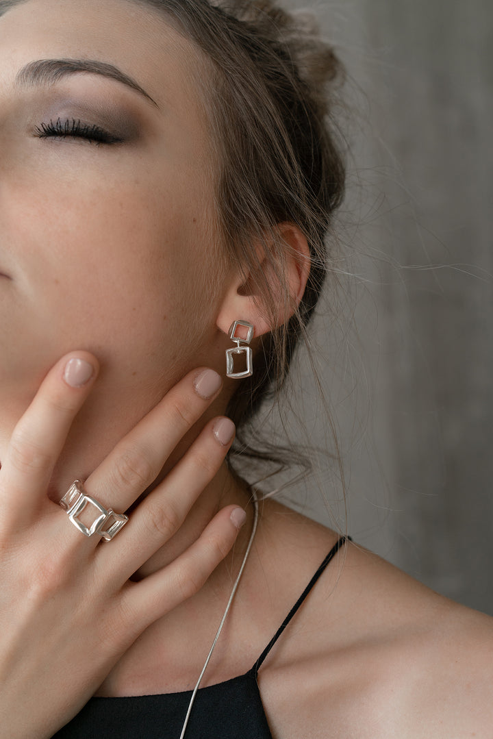 Model wearing sterling silver BUTO earrings by Kim Paquet