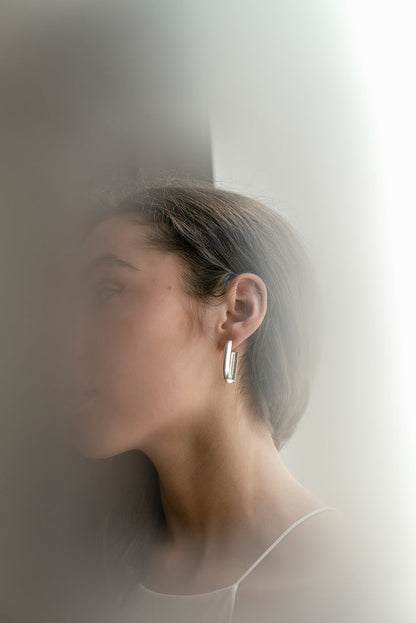 Model wearing sterling silver CASO earrings by Kim Paquet