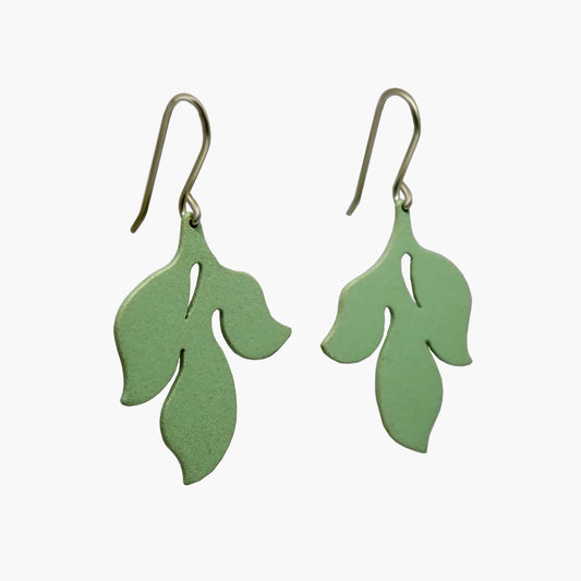 Pair of elegant hanging earrings with a flat, leaf-shaped silhouette in a soft, pale green color.