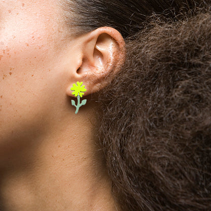 Pair of mix-and-match flower earrings in orange and yellow, featuring intricate detailing and a glossy finish, with secure post backings and measuring approximately 1 inch in diameter.