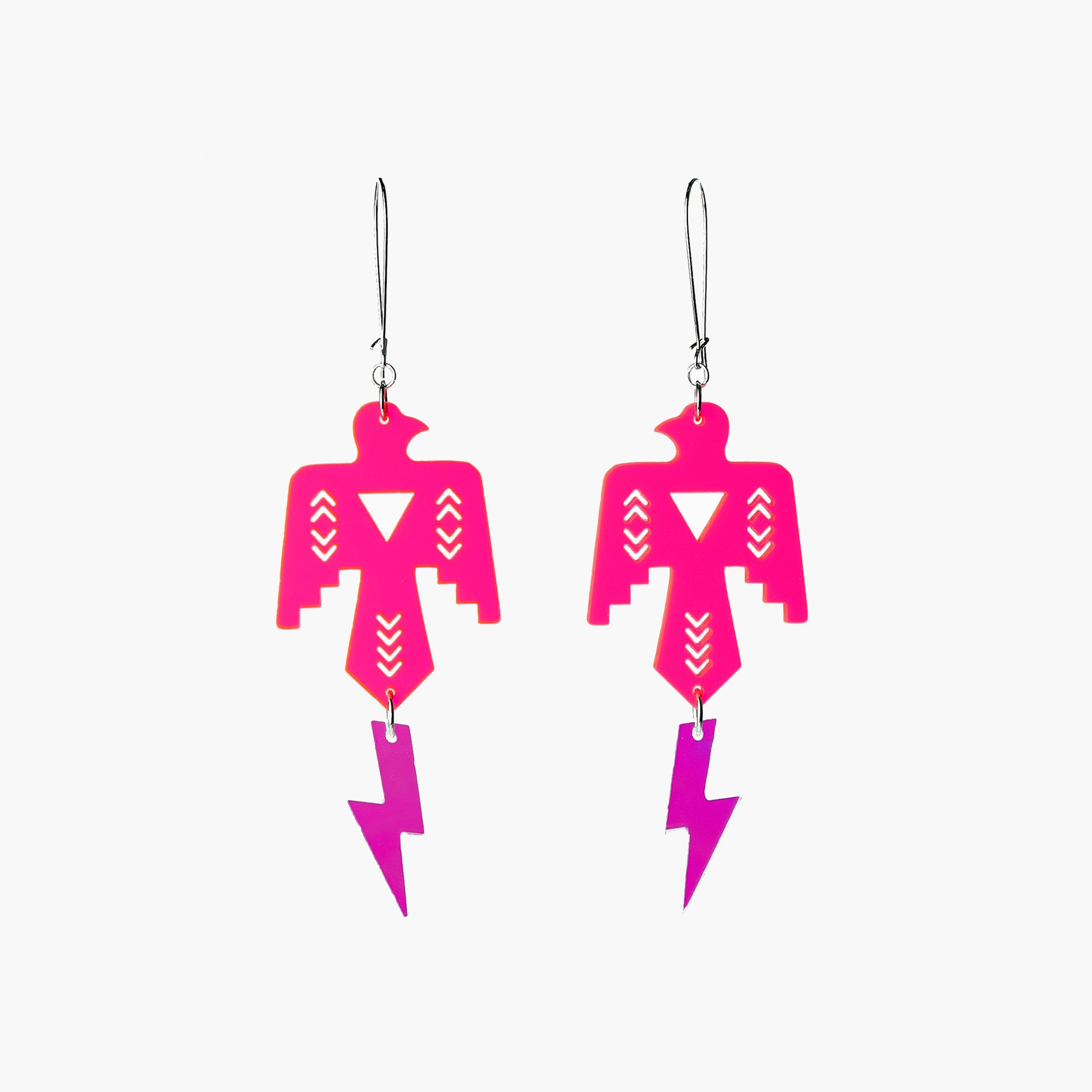 Front view Image of Indi City Thunderbird-themed earrings in neon pink with iridescent lightning bolt accents, representing the revival of indigenous Thunderbeing symbolism within contemporary design.