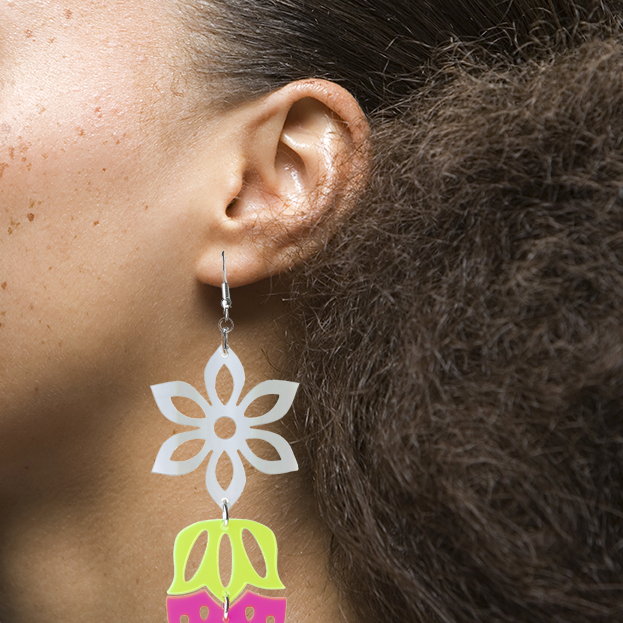 Model view mage of Heart Berries earrings, referred to as Otehimin in Cree, crafted from transparent acrylic, with a transparent iridescent acrylic flower. These long drop earrings beautifully merge elements of both traditional and modern aesthetics, featuring a striking strawberry motif.