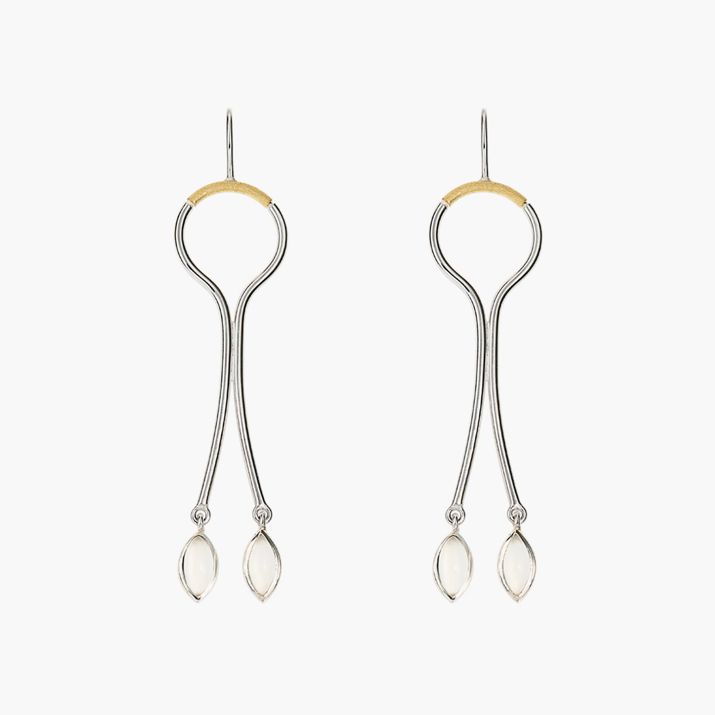 Sterling silver hanging earrings with curving wire design, accented with gold and featuring moonstone drops.