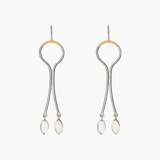 Sterling silver hanging earrings with curving wire design, accented with gold and featuring moonstone drops.