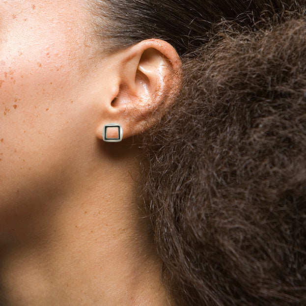 Model wearing sterling silver MANO earrings by Kim Paquet